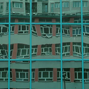 FILE PHOTO: Block of flats is reflected in the windows of an office building in Warsaw