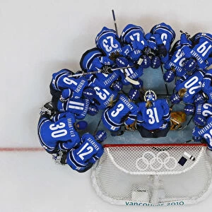 Finlands players gather during a pregame ritual before their womens ice hockey play-offs