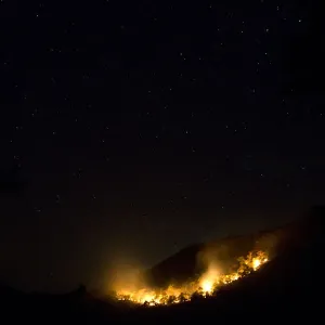 Fire blazes at the Jaragua Hills ecological reserve park under the night sky in Goias Fire blazes at the Jaragua Hills ecological reserve park under the night sky in Goias