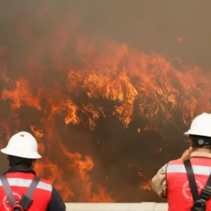 Fire is seen on a hill, where more than 100 homes were burned due to forest fire but Fire is seen on a hill, where more than 100 homes were burned due to forest fire but