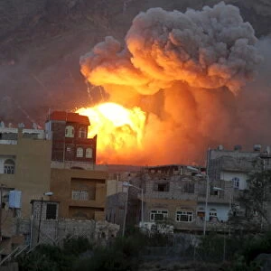 Fire and smoke billows from an army weapons depot after it was hit by an air strike in