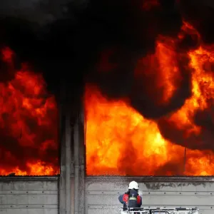 A fireman tries to extinguish a fully developed fire at a plastic factory in Istanbul A fireman tries to extinguish a fully developed fire at a plastic factory in Istanbul