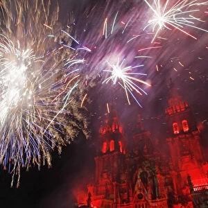 Fireworks explode over an ancient cathedral in Santiago de Compostela during celebrations