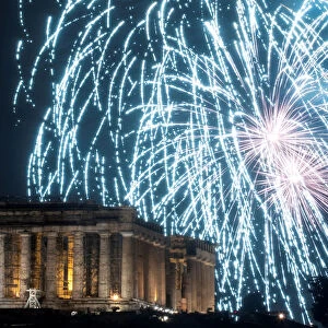 Fireworks explode over the ancient Parthenon temple atop the Acropolis hill during