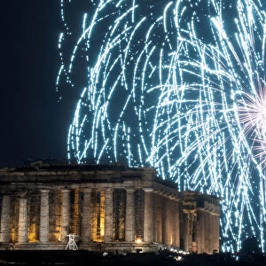 Fireworks explode over the ancient Parthenon temple atop the Acropolis hill during New
