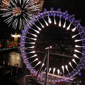 Fireworks explode from The Big Ben clock tower and the London Eye during New Year