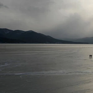 Fishermen walk along the frozen Yenisei River in the Taiga district outside Russia s