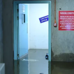 Flood water is seen at a doorway in a multi-storey car park as flood waters reached up to Flood water is seen at a doorway in a multi-storey car park as flood waters reached up to