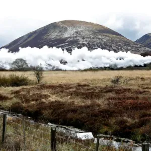 The Flying Scotsman steam train travels north through the Drumochter Pass, Scotland The Flying Scotsman steam train travels north through the Drumochter Pass, Scotland