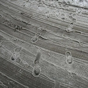 Footprints are left in the slush on a street during a snow storm in downtown New York