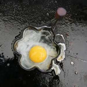 A fried egg is seen on a grill in a roadside snack cafe along the A49 near Tittensor A fried egg is seen on a grill in a roadside snack cafe along the A49 near Tittensor