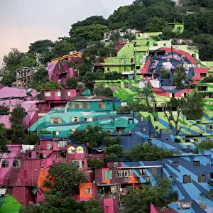 A general view shows colorful painted houses on the side of a hill in neighbourhood Cerro