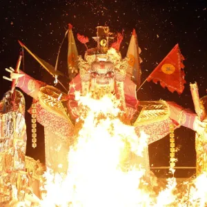 A giant paper statue of Chinese deity Da Shi Ye is burnt during the Chinese Hungry Ghost