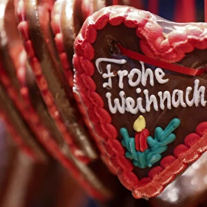 Gingerbread hearts, decorated with icing reading Merry Christmas are displayed for