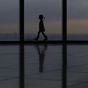 A girl walks at an observation deck in Tokyo