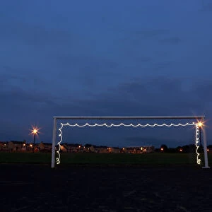 A goalpost is illuminated by a flashlight