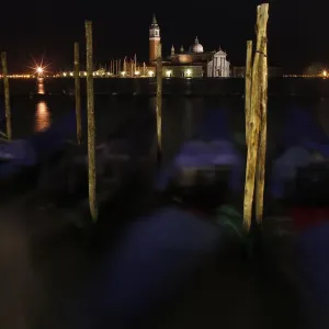 Gondolas are seen along the Canal Grande in front of San Giorgio Maggiore church in