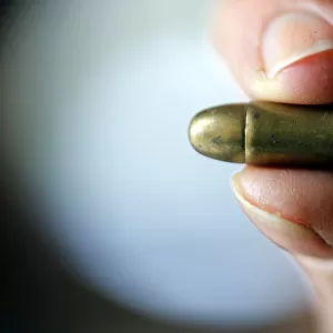 A guns collector holds a 7. 65 caliber bullet in his house in Bordeaux