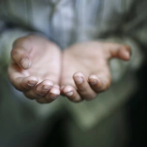 A hand of a Muslim boy offering prayer is pictured during the holy fasting month of