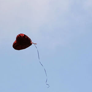 A heart-shaped balloon floats upward during the Seventh Anniversary September 11 Commemoration