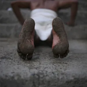 A Hindu devotees feet are seen while he rolls on the ground during the first day of