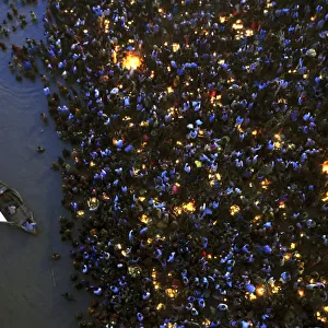 Hindu devotees gather to worship the Sun god Surya on the banks of the Ganges river