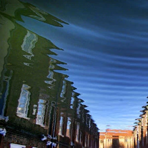 Houses in Colenso Street, York are reflected as abstract patterns in flood water