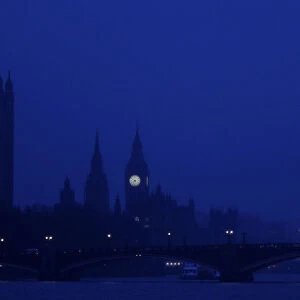 The Houses of Parliament are seen in early morning mist in central London