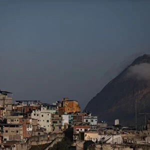 Houses at the Santo Amaro slum are seen with the Sugar Loaf mountain in the background