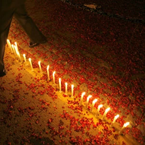 Indian soldier crosses over candles lit by school children during Vijay Divas in New