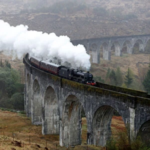 The Jacobite steam train crosses the Glenfinnan Viaduct in Scotland