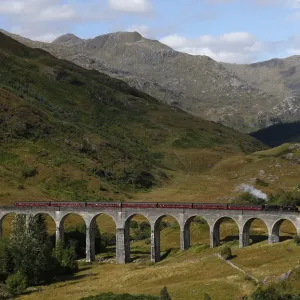 The Jacobite steam train crosses the Glenfinnan Viaduct in Scotland The Jacobite steam train crosses the Glenfinnan Viaduct in Scotland