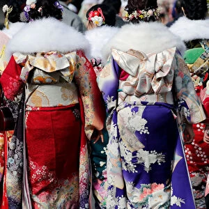 Japanese women wearing kimonos attend their Coming of Age Day celebration ceremony at an