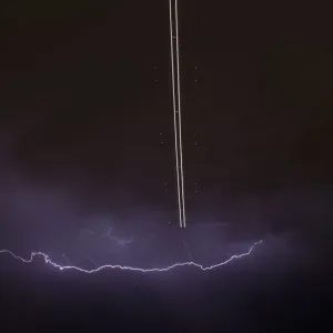 Jet aircraft takes off as lightning strikes across the sky during a monsoon storm Jet aircraft takes off as lightning strikes across the sky during a monsoon storm