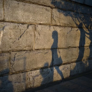 Late afternoon shadows are cast on the seawall along the inner harbour in Victoria