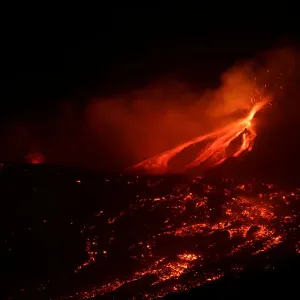 Lava and plumes of smoke erupt from Mount Etna