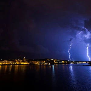 Lightning bolts are seen during a storm over Valletta