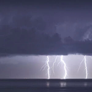 Lightnings strike in the sea off the shore of Artemida