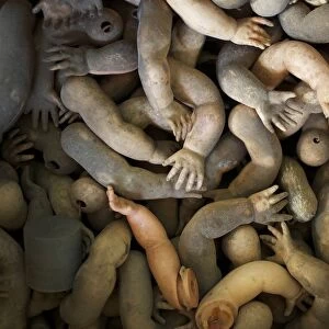 Limbs of dolls are shown as spare parts in a pile ready to be used in customers doll