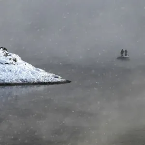 Two local residents row on a boat through a frosty fog as they cross the Shumikha Two local residents row on a boat through a frosty fog as they cross the Shumikha