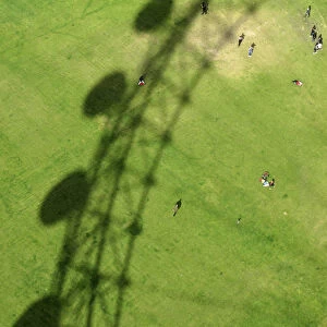 The London Eye casts a shadow on Jubilee Gardens in London