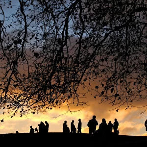 LONDONERS WATCH SUNSET OVER CITY FROM PRIMROSE HILL