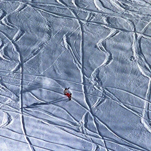 A lone snowboarder slides down a hill near the ski resort of Arosa