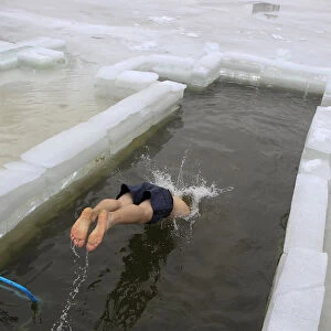 A man dives into the icy waters of a lake during Orthodox Epiphany celebrations in Minsk