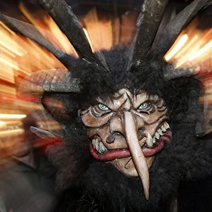 A man dressed as Krampus creature takes part in a parade at Munichs Christmas market
