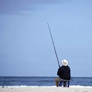 A man fishes at the beach at Bettys Bay near Kleinmond
