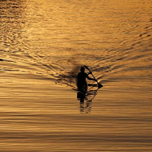 A man paddles in the Yarkon river in Tel Aviv