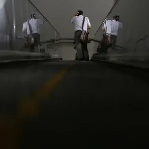 A man rides an escalator at a subway station in Beijing