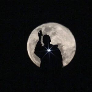 Man is seen photographing the full moon in Brasilia