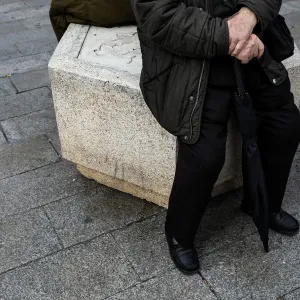 A man sits on the street in central Madrid